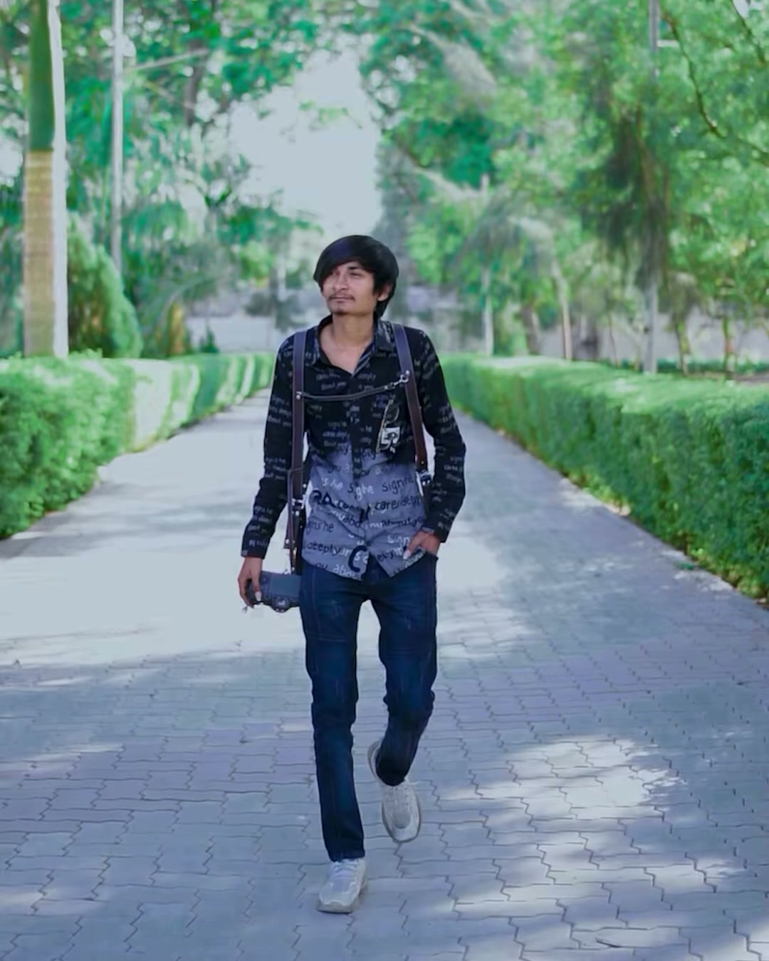 Raj Kuvariya, owner / cinematographer, walking with his camera